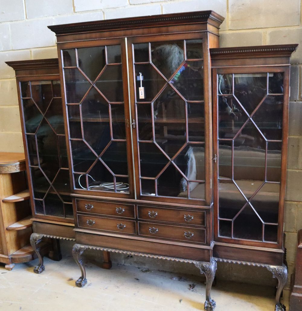 A Chippendale style mahogany breakfront display cabinet fitted four astragal-glazed doors, on cabriole legs with claw and ball feet,